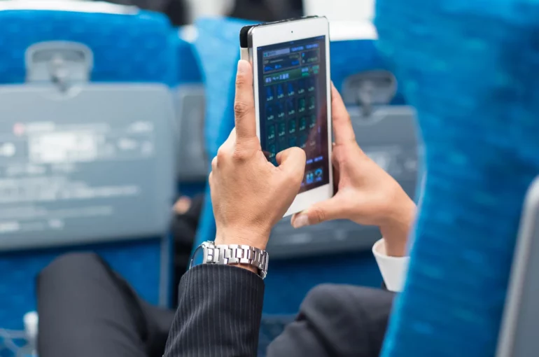 Businessman-tablet-phone-airplane